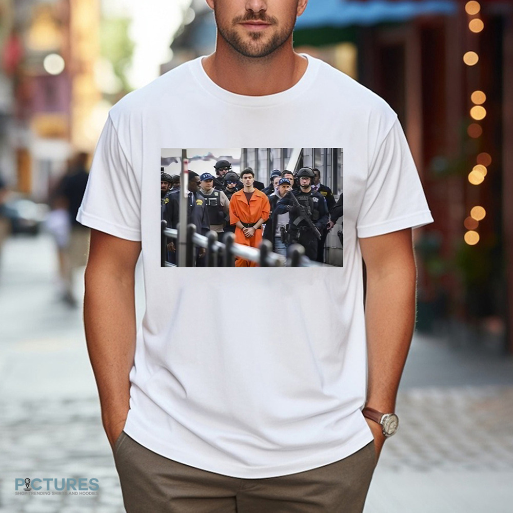 Luigi Mangione Arrives At A Helicopter Pad With Police New York Shirt