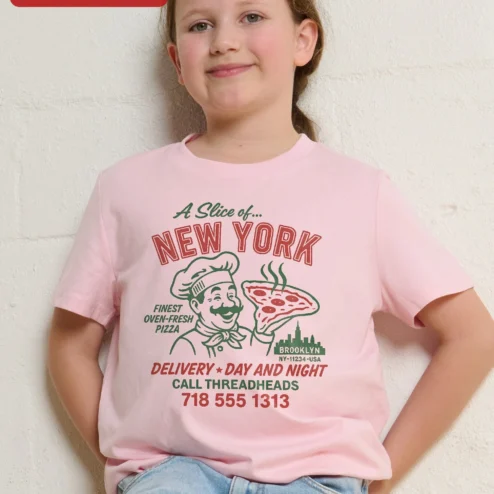 A Slice of New York Pizza Delivery Day and Night Kids Tee Retro Vintage Graphic Shirt on a hanger, ready to ship from Chicago, Illinois