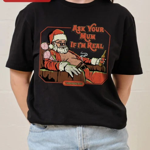 Ask Your Mum If I'm Real Tee Funny Santa Claus Graphic Shirt for Adults on a hanger, ready to ship from Chicago, Illinois