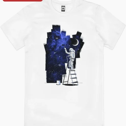 Astronaut Painting Galaxy Tee Surreal Space Artist Graphic Shirt for Dreamers on a hanger, ready to ship from Chicago, Illinois