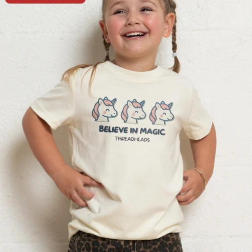 Believe In Magic Unicorn Kids Tee Cute Cartoon Graphic T-Shirt For Toddlers on a hanger, ready to ship from Chicago, Illinois