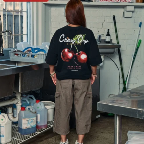 Cherry Graphic Tee Oversized Black Cotton Shirt Minimalist Red Cherry Print Streetwear Apparel for W on a hanger, ready to ship from Chicago, Illinois