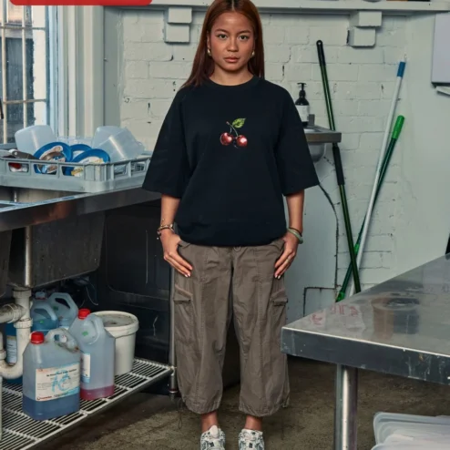 Customer in Chicago, Illinois wearing Cherry Graphic Tee Oversized Black Cotton Shirt Minimalist Red Cherry Print Streetwear Apparel for W