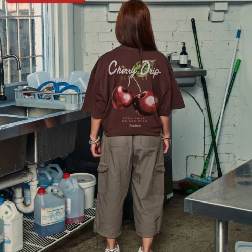 Close-up of Cherry Graphic Tee Oversized Black Cotton Shirt Minimalist Red Cherry Print Streetwear Apparel for W for streetwear fans in Chicago, Illinois