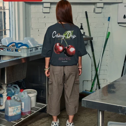 Close-up of Cherry Graphic Tee Oversized Black Cotton Shirt Minimalist Red Cherry Print Streetwear Apparel for W for streetwear fans in Chicago, Illinois