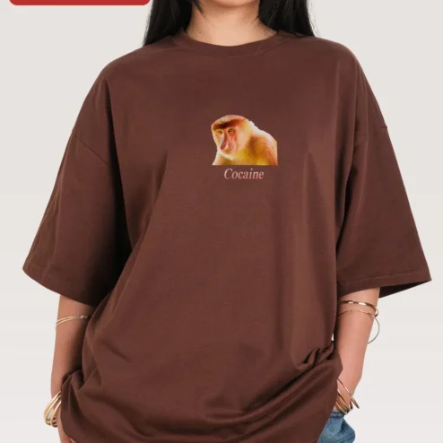 Cocaine Tee Surreal Proboscis Monkey Graphic Oversized Streetwear Shirt on a hanger, ready to ship from Chicago, Illinois