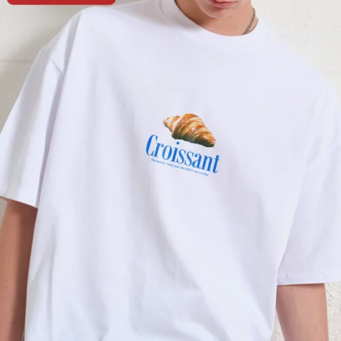 Croissant The Buttery Twist Your Diet Didn't See Coming Funny Foodie Graphic Tee on a hanger, ready to ship from Chicago, Illinois