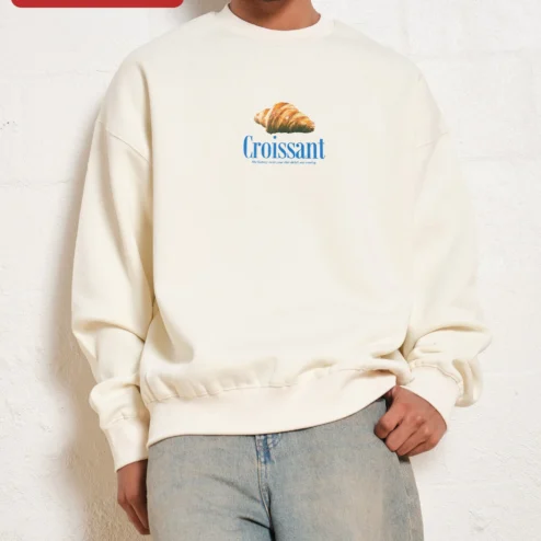 Croissant The Buttery Twist Your Diet Didn't See Coming Funny Foodie Sweatshirt on a hanger, ready to ship from Chicago, Illinois
