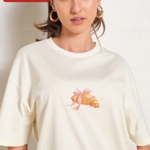 Croissant with Pink Bow Graphic Tee Cute French Pastry Shirt for Women on a hanger, ready to ship from Chicago, Illinois