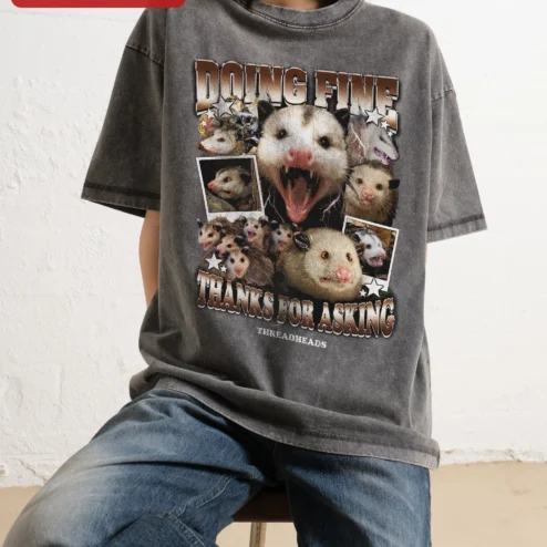 Doing Fine Thanks For Asking Opossum Meme Tee Funny Sarcastic Graphic Shirt for Introverts on a hanger, ready to ship from Chicago, Illinois