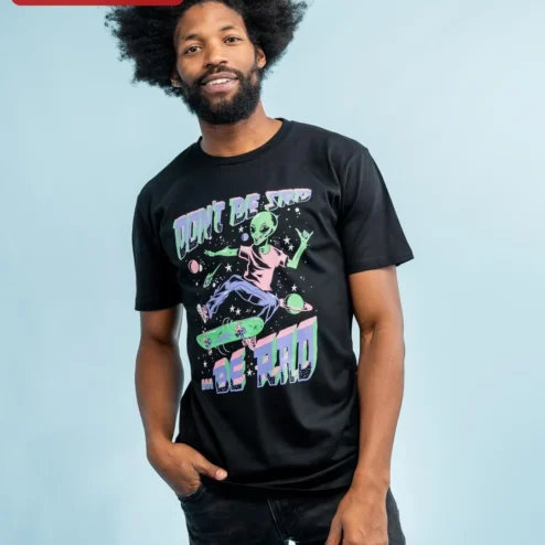 Don't Be Sad Be Rad Alien Skateboarding Graphic Tee Retro Space Humor Shirt on a hanger, ready to ship from Chicago, Illinois