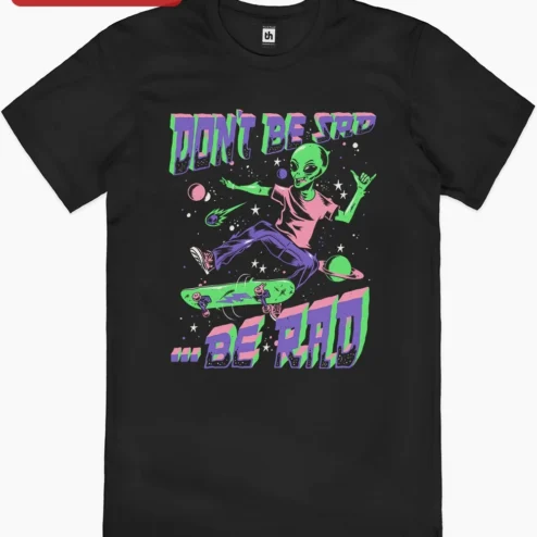 Close-up of Don't Be Sad Be Rad Alien Skateboarding Graphic Tee Retro Space Humor Shirt for streetwear fans in Chicago, Illinois