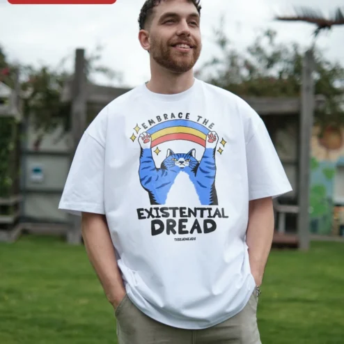 Embrace The Existential Dread Cat Tee Dark Humor Graphic T-Shirt Gift on a hanger, ready to ship from Chicago, Illinois
