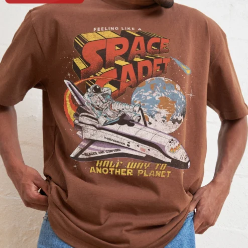 Feeling Like A Space Cadet Half Way To Another Planet Retro Astronaut Graphic Tee on a hanger, ready to ship from Chicago, Illinois