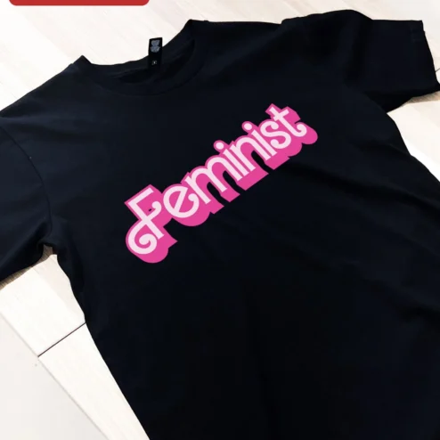 Customer in Chicago, Illinois wearing Feminist Tee Retro Y2K Pink Typography Statement Shirt for Women