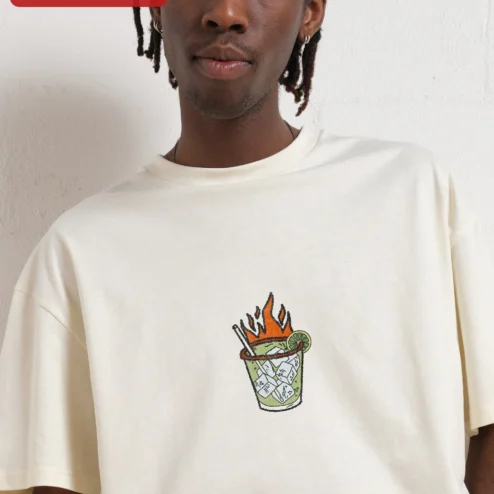 Close-up of Flaming Tropical Cocktail Illustration Tee Retro Tiki Drink Graphic Shirt for Summer Party for streetwear fans in Chicago, Illinois