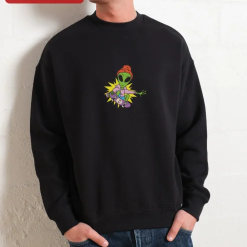 Green Alien Riding Skateboard Cartoon Graphic Crewneck Sweatshirt for Women on a hanger, ready to ship from Chicago, Illinois
