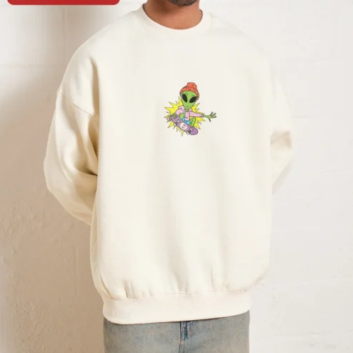 Close-up of Green Alien Riding Skateboard Cartoon Graphic Crewneck Sweatshirt for Women for streetwear fans in Chicago, Illinois