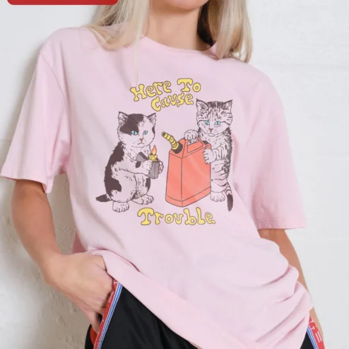 Here To Cause Trouble Tee Funny Mischievous Cats Retro Cartoon Graphic Shirt on a hanger, ready to ship from Chicago, Illinois