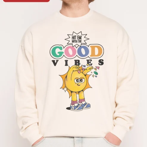 Hit Em With The Good Vibes Sweatshirt Retro Cartoon Sun Positive Energy Crewneck on a hanger, ready to ship from Chicago, Illinois