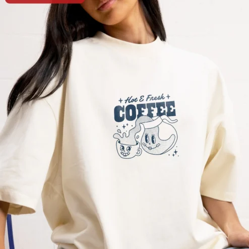 Hot Fresh COFFEE Retro Cartoon Graphic Tee for Coffee Lovers and Baristas on a hanger, ready to ship from Chicago, Illinois
