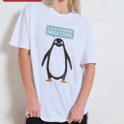 I Am Fucking Freezing Funny Penguin Graphic Tee Winter Humor Gift on a hanger, ready to ship from Chicago, Illinois