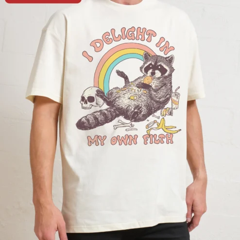 I Delight In My Own Filth Tee Funny Raccoon Trash Panda Graphic Shirt on a hanger, ready to ship from Chicago, Illinois