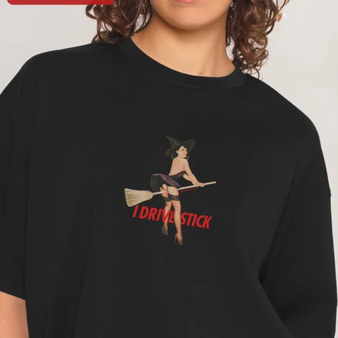 I Drive Stick Tee Vintage Pin Up Witch Halloween Manual Transmission Shirt on a hanger, ready to ship from Chicago, Illinois