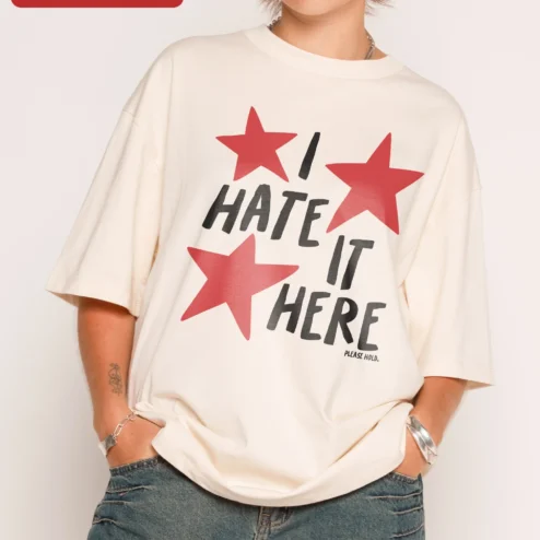 I Hate It Here Please Hold Graphic Tee Unofficial Taylor Swift Lyric Meme Shirt for Introverts on a hanger, ready to ship from Chicago, Illinois