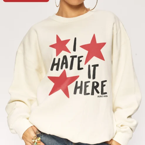 I HATE IT HERE Sweatshirt Taylor Swift Lyric Inspired Graphic Crewneck for Fans on a hanger, ready to ship from Chicago, Illinois