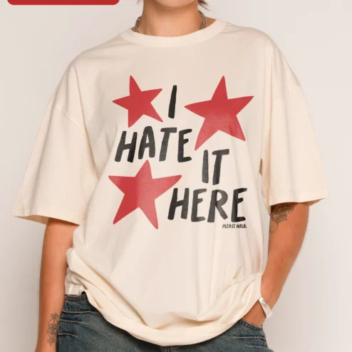 I Hate It Here Tee Funny Sarcastic Introvert Meme Shirt Unofficial Fan Gift on a hanger, ready to ship from Chicago, Illinois