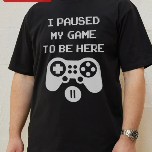 I Paused My Game To Be Here Funny Gamer Tee Gift for Men Women on a hanger, ready to ship from Chicago, Illinois