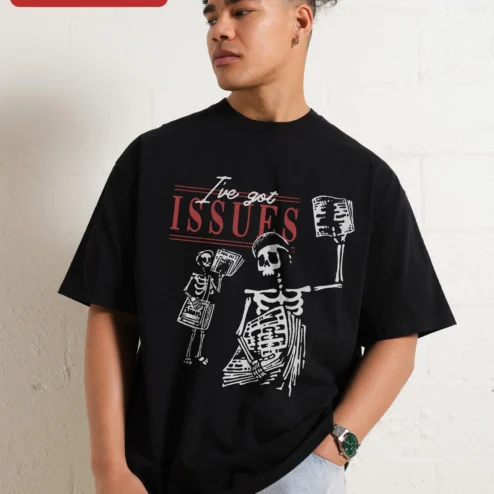 I've Got Issues Tee Skeleton Newspaper Graphic Oversized Gothic Humor Shirt on a hanger, ready to ship from Chicago, Illinois