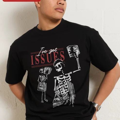 I've Got Issues Tee Skeleton Newspaper Graphic T-Shirt Gothic Humor Sarcastic Gift for Adults on a hanger, ready to ship from Chicago, Illinois