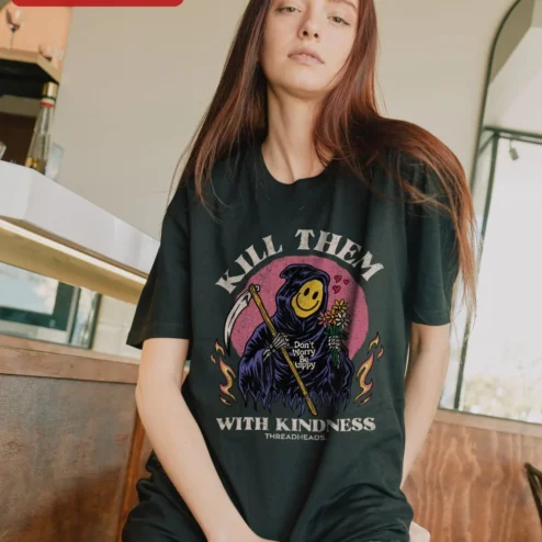 Kill Them With Kindness Grim Reaper Smiley Face Tee Don't Worry Be Happy Quote Shirt on a hanger, ready to ship from Chicago, Illinois