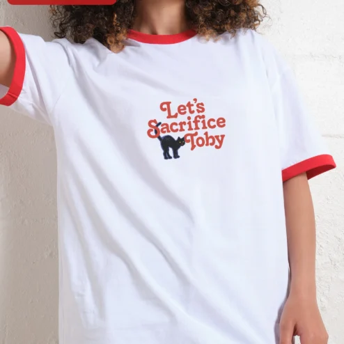 Close-up of Let's Sacrifice Toby Tee Funny Black Cat Retro Ringer Shirt Gift for Men Women for streetwear fans in Chicago, Illinois