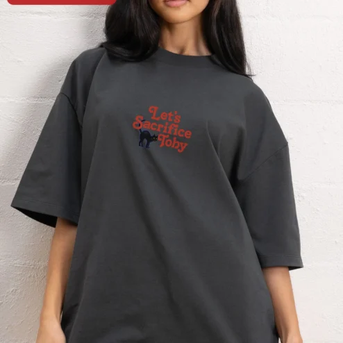 Let's Sacrifice Toby Tee Retro Black Cat Graphic T-Shirt Funny Dark Humor Gift for Cat Owners on a hanger, ready to ship from Chicago, Illinois