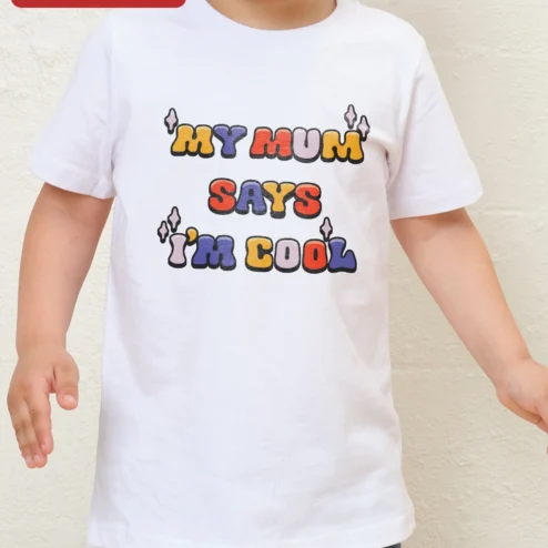Customer in Chicago, Illinois wearing 'MY MUM' SAYS 'I'M COOL' Kids Tee Funny British Mum Quote Graphic T-Shirt for Children
