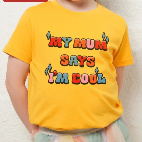 Close-up of 'MY MUM' SAYS 'I'M COOL' Kids Tee Funny British Mum Quote Graphic T-Shirt for Children for streetwear fans in Chicago, Illinois