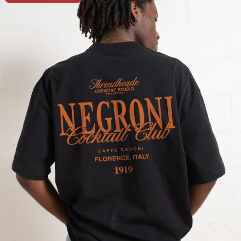 Negroni Cocktail Club Tee Vintage Bar Sign Graphic Shirt for Bartenders Cocktail Enthusiasts on a hanger, ready to ship from Chicago, Illinois