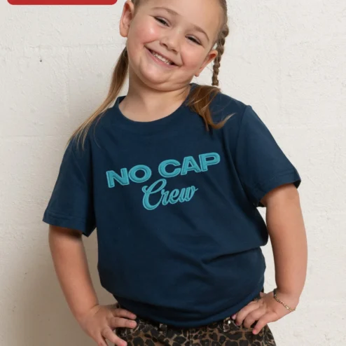 Customer in Chicago, Illinois wearing NO CAP Crew Kids Tee Black Embroidered Streetwear Shirt for Girls Gen Alpha Slang Apparel