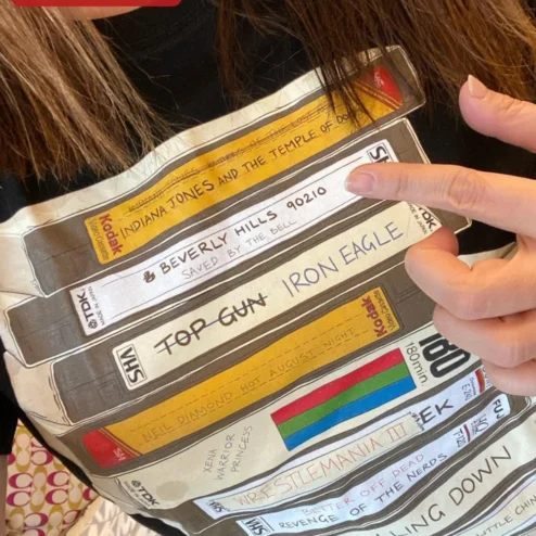 Retro VHS Tapes Stack Graphic Tee 80s Nostalgia Vintage Video Cassette Shirt for Movie Buffs on a hanger, ready to ship from Chicago, Illinois