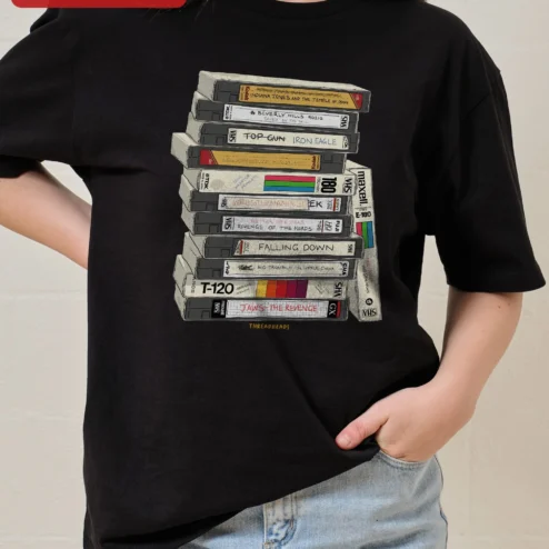 Customer in Chicago, Illinois wearing Retro VHS Tapes Stack Graphic Tee 80s Nostalgia Vintage Video Cassette Shirt for Movie Buffs
