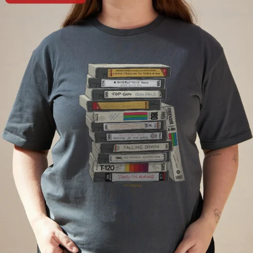 Customer in Chicago, Illinois wearing Retro VHS Tapes Stack Graphic Tee 80s Nostalgia Vintage Video Cassette Shirt for Movie Buffs