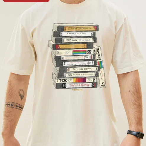 Close-up of Retro VHS Tapes Stack Graphic Tee 80s Nostalgia Vintage Video Cassette Shirt for Movie Buffs for streetwear fans in Chicago, Illinois