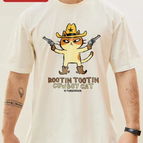 Rootin Tootin Cowboy Cat Tee Funny Western Graphic Shirt for Cat Lovers on a hanger, ready to ship from Chicago, Illinois