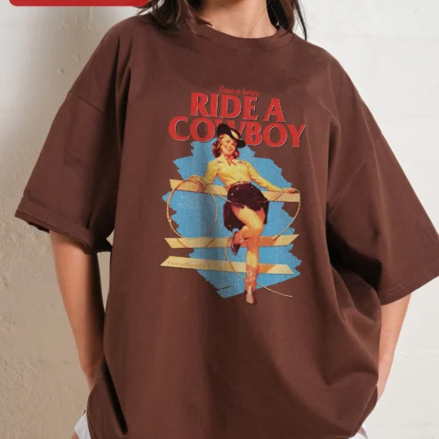Save a Horse Ride a Cowboy Graphic Tee Retro Western Pin Up Cowgirl Shirt Funny Country Gift for Wom on a hanger, ready to ship from Chicago, Illinois