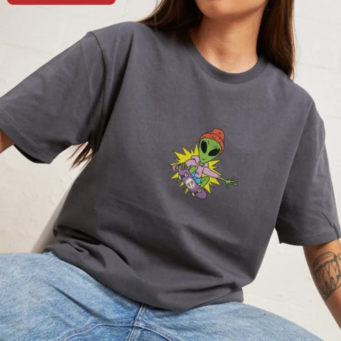 Skateboarding Alien Graphic Tee Funny Retro Sci-Fi Skateboard Shirt for Teens on a hanger, ready to ship from Chicago, Illinois