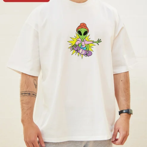 Skateboarding Alien Graphic Tee Retro Sci-Fi Streetwear Shirt for Teens on a hanger, ready to ship from Chicago, Illinois