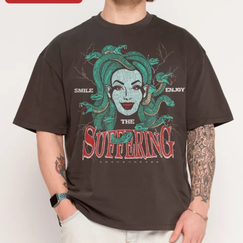 Smile Enjoy The Suffering Medusa Graphic Tee Dark Humor Mythology Shirt on a hanger, ready to ship from Chicago, Illinois